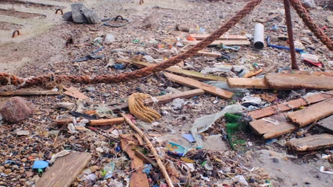 Plastic and other garbage pollution on the embankment after a sea storm Stock Footage 169107583