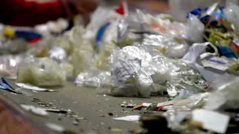 Plastic and packaging waste is being carried by conveyor belts at the factory as 動画素材 334662006