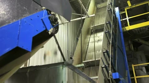 Plastic and packaging waste is being carried by conveyor belts at the factory as 動画素材 334662134