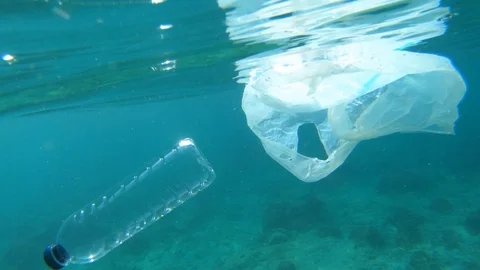 Plastic bag and plastic bottle trash in ocean. Stock Footage 110752963