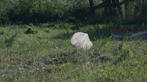 Plastic bag garbage floating in the wind in a field in slow motion. Stock Footage 93572381