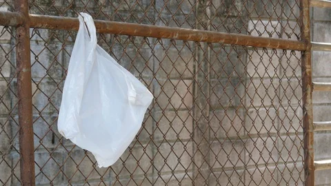 A plastic bag hang on rusty mesh fence. Stock Footage 128271257