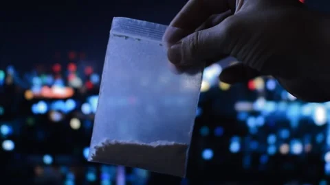 Plastic bag with illegal white cocaine powder in a night city background. Stock Footage 219928816