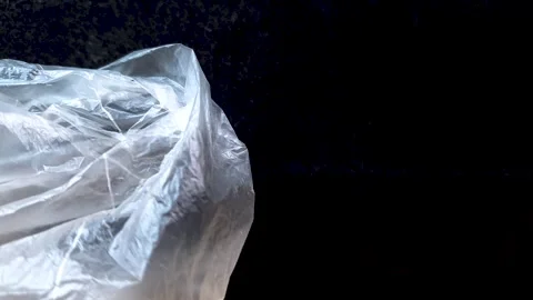 Plastic bag, plastic wrap. Plastic bag on a background of black Stock Footage 279116770