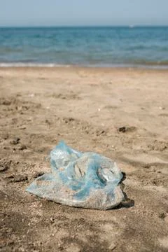 Plastic bag on a sandy beach. Stock Photos