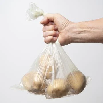 A plastic bag with some potatoes 库存照片