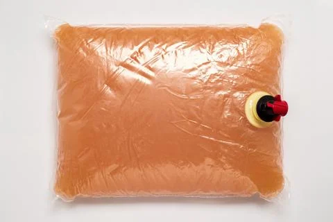 Plastic bag with tap full of apple juice Stock Photos