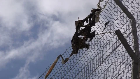 Plastic bags are stuck in the security fence between Israel and the West Bank Stock Footage 71486414