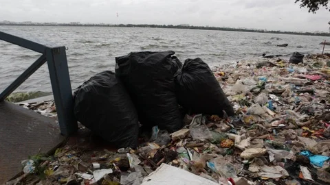 Plastic-bags-filled-with-recyclable-material-banks-of-hussain-sagar-lake-hyde Stock Footage 94011883