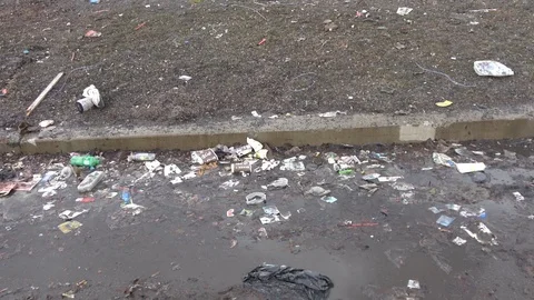 Plastic bags , paper cups , garbage, debris on residential city land Video stock 106605751