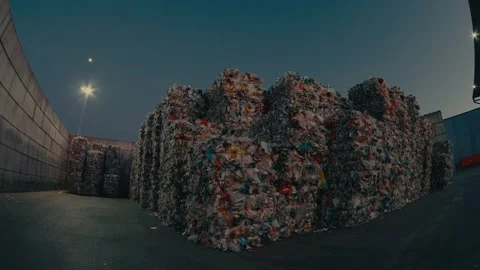 Plastic Bales Stacked in an Outdoor Storage Area at a Recycling Facility Stock Footage 331166580
