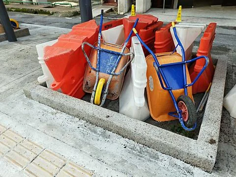 Plastic barriers and two wheelbarrows Stock Photos