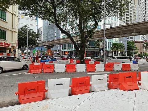 Plastic barriers are placed on the side of the road during construction Stock Photos