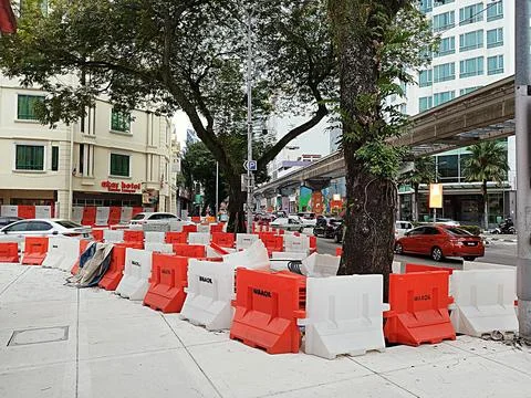 Plastic barriers are placed on the side of the road during construction Stock Photos