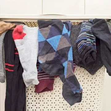 Plastic basket full of socks Stock Photos