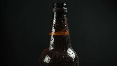 Plastic beer bottle on black background Stock Footage 144437247