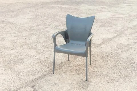 Plastic black chair on the gray background Stock Photos