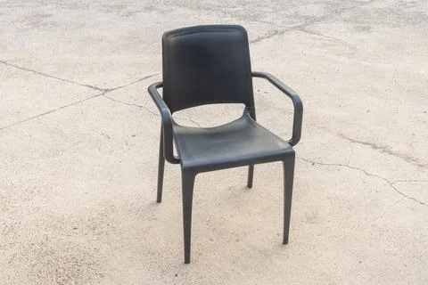 Plastic black chair on the gray background Stock Photos