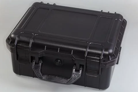 Plastic black portable toolbox on a gray background Stock Photos