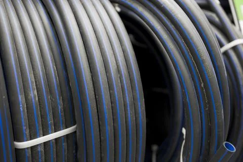 Plastic black rolled up hose texture background Foto stock