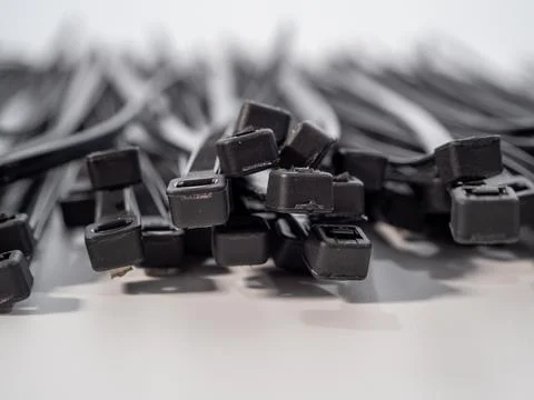 Plastic black ties on a white background. Stock Photos