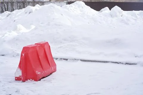 A plastic block on a background of white snow. Traffic difficulties due to the Stock Photos