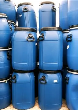Plastic blue barrels for storing various raw materials for industry and agr.. Stock Photos