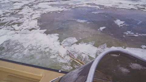 Plastic boat that makes its way through the ice on the river Stock Footage 102345681