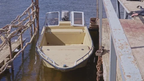 Plastic boat at the pier on the river Stock Footage 102345429