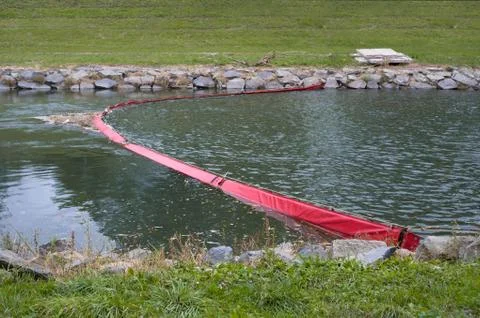 Plastic boom in the river. Obstacle blocks dirt and pollutant Stock Photos
