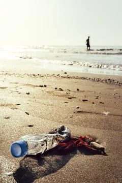 Plastic bottle and garbage pollute a beach Stock Photos