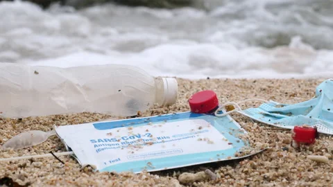 Plastic bottle and spoon, used face mask, self test for COVID-19 trash on the Stock Footage 199659533