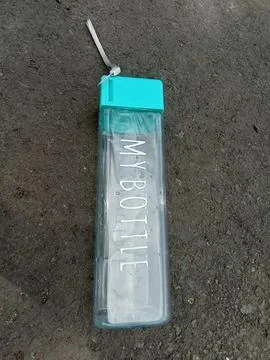 A plastic bottle on an asphalt background. Фото