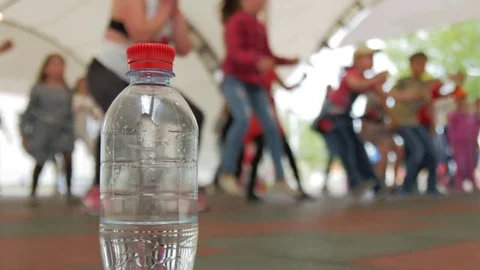 Plastic bottle on the background of a group of people engaged in Zumba fitness. Stock Footage 75245195