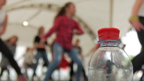 Plastic bottle on the background of people involved in sports. Stock Footage 75245052