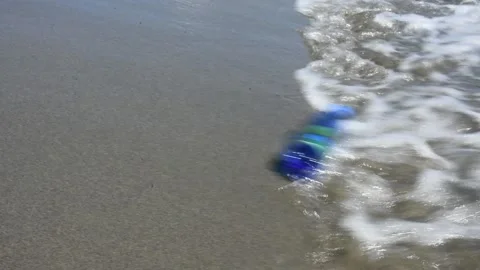 Plastic bottle on the beach Stock Footage