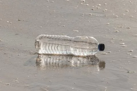 Plastic bottle on beach sand Stock Photos