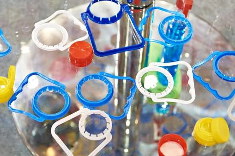 Plastic bottle caps and cap holders Stock Photos