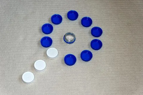Plastic Bottle Caps Arranged in Circular Pattern Representing Recycling Conc Stock Photos