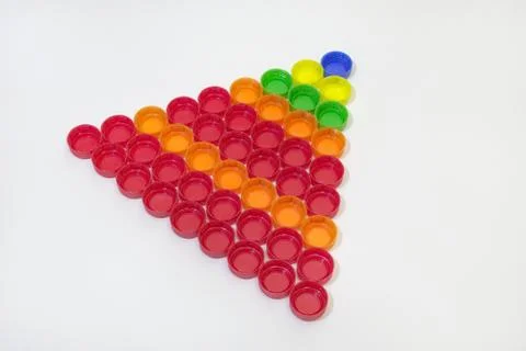 Plastic bottle caps, collected in regular triangular pyramid 写真素材