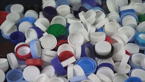 Plastic bottle caps falling in slow motion Stock Footage 124644699