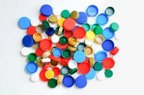 Plastic bottle caps on a white background. View from above. Stock Photos