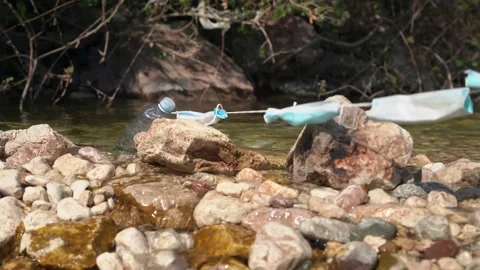 Plastic bottle caught on elastic drawstring of used and improperly disposed Video stock 156833250