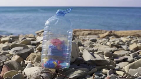 Plastic bottle on the coast. Ocean pollution Stock Footage 185105145