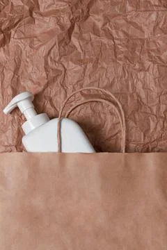 Plastic bottle on craft background. High density polyethylene packaging for r Stock Photos