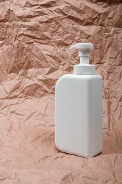 Plastic bottle on craft background. High density polyethylene packaging for r Stock Photos