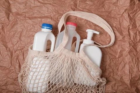 Plastic bottle on craft background. High density polyethylene packaging for r Stock Photos