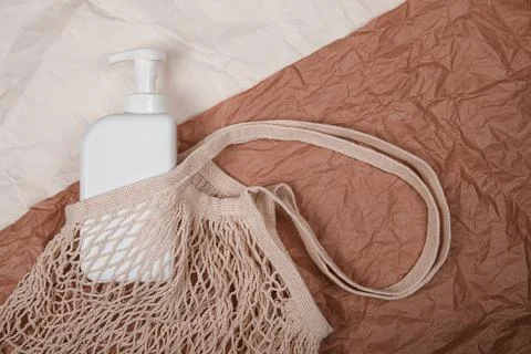 Plastic bottle on craft background. High density polyethylene packaging for r Stock Photos