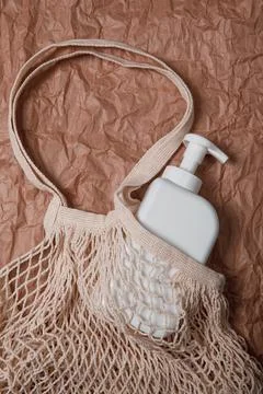 Plastic bottle on craft background. High density polyethylene packaging for r Stock Photos