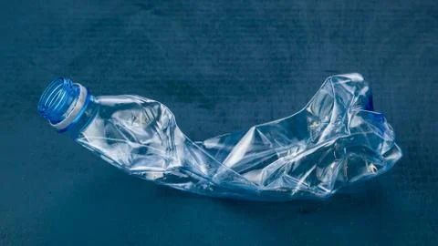 Plastic bottle on dark blue background. The concept of ecology. Stock Photos